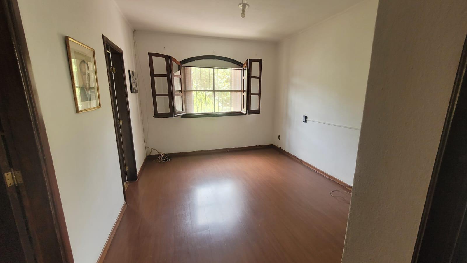 Ambiente com piso de madeira e janela em arco